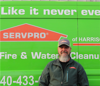 male employee wearing a SERVPRO® hat and jacket